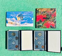Four Canadian coin proof sets displayed with cases and packaging showing 1995 and 1996 themes, including polar bear and maple leaf.