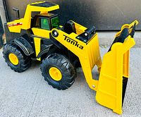 Front angle view of the Tonka Classics front end loader toy showing yellow bucket and black tires.