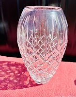 Side view of the crystal vase showing the detailed cut pattern and shape.