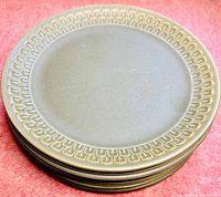 Stack of 9 green stoneware Wedgwood dinner plates with patterned rims.