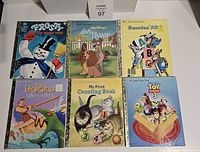 Front covers of 6 Little Golden Books showing titles and colorful illustrated characters including Frosty the Snowman, Lady and the Tramp, Bunnies' ABC, Hercules, My First Counting Book, and Toy Story 3.