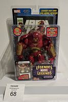 Front view of sealed Iron Man Hulk Buster figure in packaging with comic book and Marvel Legends branding
