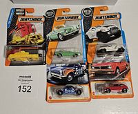 Photo of all five Matchbox cars still sealed in original packaging, showing front view and packaging details.