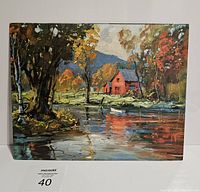 Front view of vintage litho print with red barn on lake and colorful autumn trees reflecting on water.
