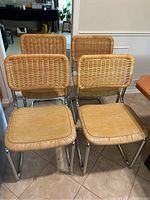 Group of four chairs arranged on tiled floor showing front elevation
