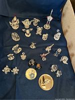 Photo showing entire collection of 27 mini crystal figurines arranged on dark cloth background with blue tray visible around edges.