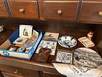 Overview of collection showing plates, coasters, wooden art, figurines, and more on wooden surface