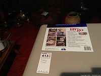 Close up of label on beige plastic tabletop showing brand Gracious Living and Lift n Go