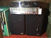 Full view of Zenith combo stereo system with turntable on top and dual speakers below, power cord visible.