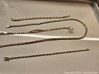 All four jewelry pieces laid out together