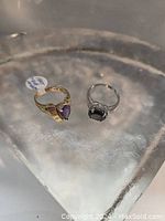 Two rings on a glass display surface, overview of both items