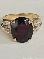 Top view of the ring showing oval garnet and diamond accents