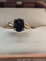 Front view showing oval black sapphire and prong setting