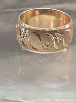 Front view of ring showing etched crescent moon and star pattern