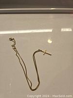 Full view of 18K yellow gold necklace with cross pendant