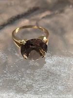 Front view of ring showing oval faceted stone and band