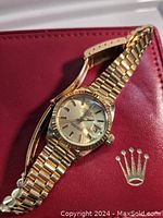 18K gold Rolex ladies watch on red presentation case with crown logo