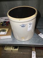Front view of the 4 gallon stoneware crock showing overall shape, interior, and visible crack inside.