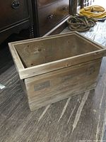 Front view of vintage wooden crate showing the Castrol branding and natural wood finish.