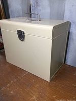 Side view of beige metal file storage box showing latch and handle
