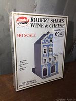 Front view of sealed kit box showing product name, brand, scale, and building image.