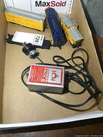 Vintage HO scale model train set items including blue engine, yellow cars with gray roofs, and a silver and red Power Pack power supply unit with cords.