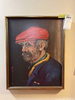 Framed autographed print of an older man in a red cap by Red Skelton.