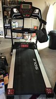 Front view of Sole C treadmill showing the running deck, control console, and side rails in a garage setting.