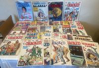 Full view of 35 Cracked magazines laid out on a surface, showing colorful covers with various themes including pop culture references and collector's editions from the 1980s.