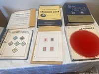 The six albums and pages included in the lot: Explorer Album, Ambassador Album, Statesman Deluxe Album, Topical Sports Collection pages, handmade Germany album pages, and the Scott's Specialty Album for Japan.