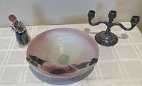 Full lot shown on table: ceramic dish in front, candelabra behind right, Norman Rockwell boy figurine behind left