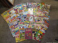 Spread of 43 colorful vintage comic books featuring Archie, Jughead, Veronica, Josie, Richie Rich and more, showing their covers and artwork styles