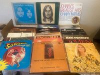 Photo showing multiple vinyl records arranged on a floor including albums by Dan Fogelberg & Tim Weisberg, Johnny Mathis, Engelbert Humperdinck, The Mamas & The Papas, Bread, and others.