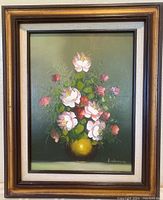 Portrait view of the full framed oil painting showing bouquet of white and pink roses in a yellow vase on a dark green background.