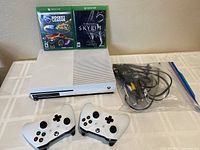 Full lot with two controllers, two game cases, Xbox One S console and cables in ziplock