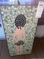 Front view of the mosaic wall art showing the nude figure and leafy motifs within a metal frame