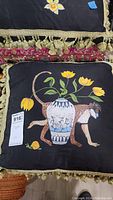 Pillow with monkey carrying a vase with yellow flowers and a snail detail
