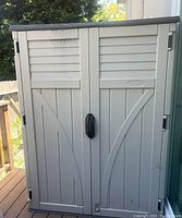 Front view of closed cabinet showing double doors and overall condition.