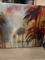 Photo showing canvas print featuring palm trees with warm color scheme.