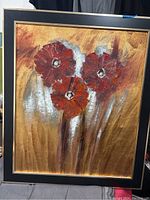 Front view of framed painting showing three large red flowers with textured petals and multi-toned metallic background