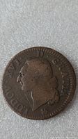 Close-up of copper coin with profile of King Louis XVI and inscription "LUDOV XVI D G RAIN".