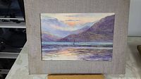 Full view of the watercolour painting showing sailboat at sunset scene with mountains and reflections on the water.