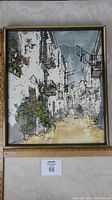 Front view of framed oil painting depicting a French street scene