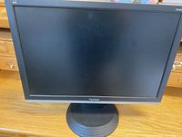 Front view of ViewSonic VA2226w computer monitor on wooden surface.