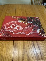 Photo of the Mikasa Christmas platter box on a wooden table with festive holiday graphics.