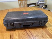 Closed black hard case with Bach logo on top, showing exterior condition and latches.