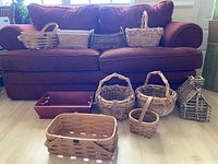 Full view of the baskets placed on floor and couch showing various shapes and sizes.