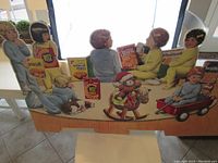 Overall view of the vintage Nabisco cardboard advertising display depicting children around cracker boxes