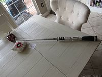 Full view of golf putter on table with Captain America shield on head cover visible.