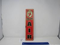 Full view of the Fire Chief Free Air metal sign on a white background with a ruler for scale.